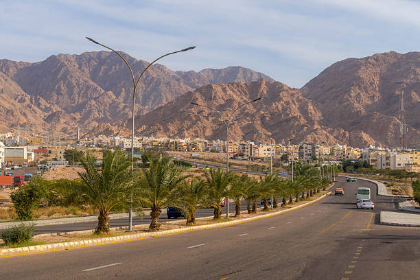istock Scenic Highway 80 stretches from Aqaba, Jordan, toward rugged Middle Eastern mountains, with desert sands and distant peaks under clear daylight 2229174741