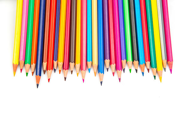 A vibrant row of sharpened colored pencils in various hues against a white background. Perfect for art supplies, creativity, and back-to-school themes.