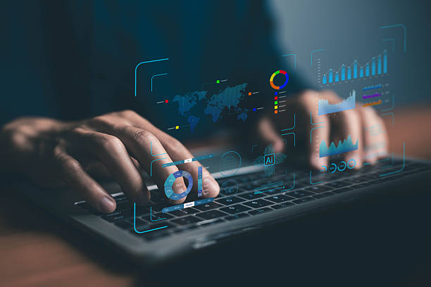 istock Close-up of hands typing on a laptop with a futuristic AI analytics dashboard, charts, data visualization for business intelligence, big data, and digital transformation concepts. report and analysis 2229177572