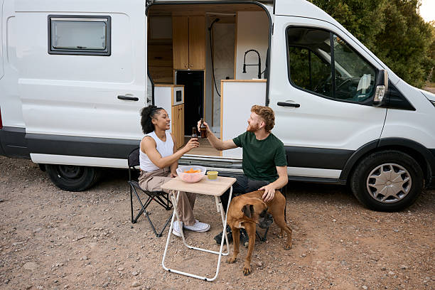 istock Couple toasting celebrating van life with their dog 2229178203