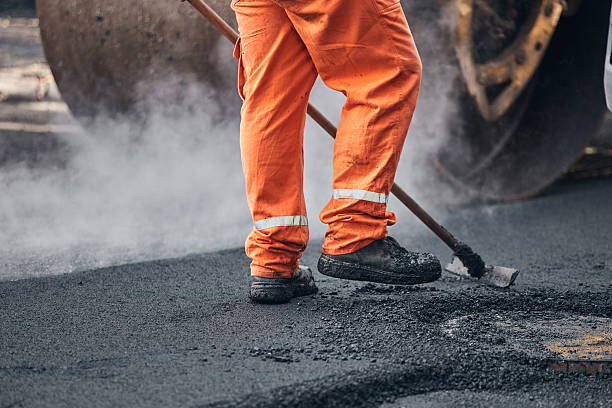 istock Construction worker working on a new asphalt layer on a public street. 2229178907