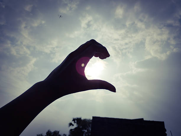 Black Dark Hand Framing the Sun