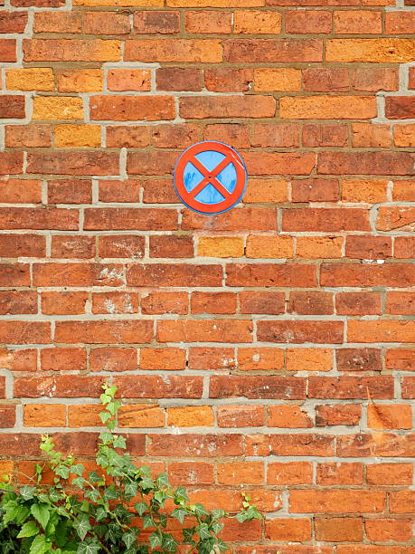 No Parking and Stopping Sign on Old Brick Wall