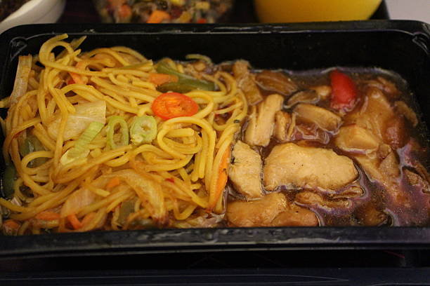 istock Economy class meal: teriyaki chicken with Chinese-style rice noodles 2229186954