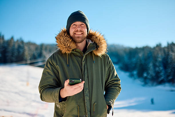istock Tourist using smartphone in snowy mountain landscape 2229187814