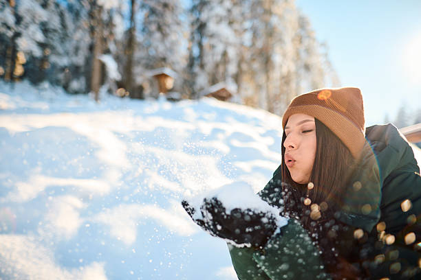 istock Young woman blowing snow in a winter forest 2229187846