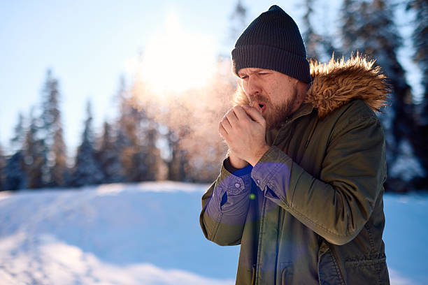 istock Man warming his hands in a snowy forest during winter 2229187935