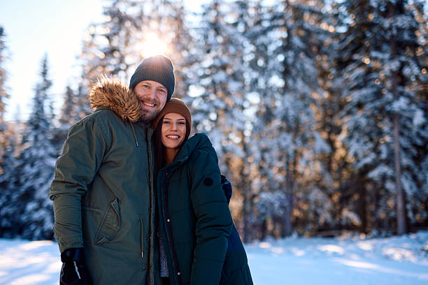 istock Happy couple hugging in snowy forest during winter holidays 2229187946