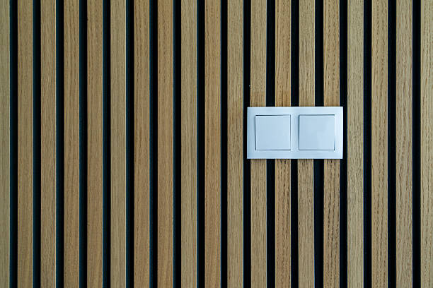 istock Light switch on wooden wall texture with wood acoustic panels 2229189055