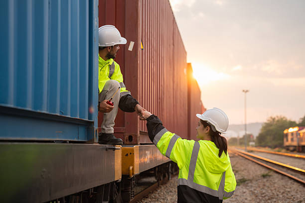 istock Foreman checking inventory or task details on freight train cars and shipping containers. Logistics concept, import, and export industries. 2229191912