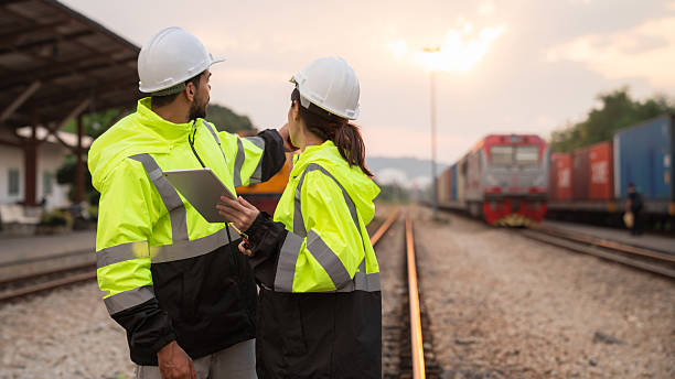 istock Foreman checking inventory or task details on freight train cars and shipping containers. Logistics concept, import, and export industries. 2229191973