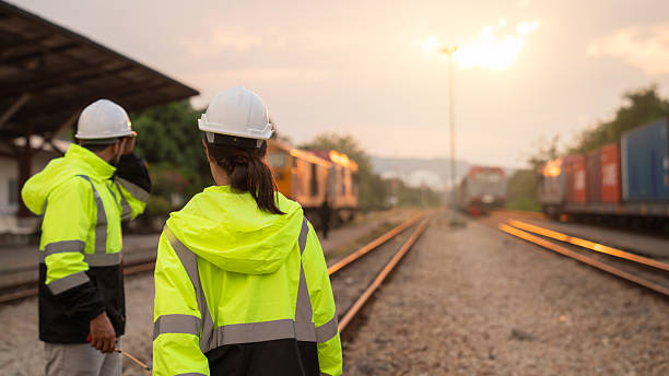 istock Foreman checking inventory or task details on freight train cars and shipping containers. Logistics concept, import, and export industries. 2229192106