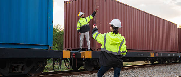 istock Foreman checking inventory or task details on freight train cars and shipping containers. Logistics concept, import, and export industries. 2229192181