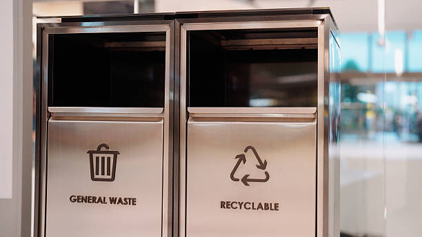istock Throwing the trash into the bin to keep the area clean and tidy 2229192950
