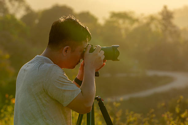 istock Landscape photographer capturing nature during golden hour evening light 2229193092