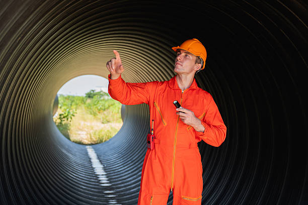 istock Engineers collaborate inside a massive steel pipe, constructing a tunnel for an industrial pipeline transporting oil, gas, and fuel. 2229193563