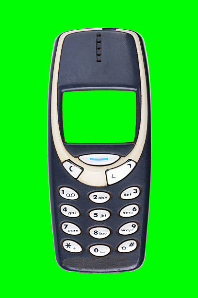 Classic mobile phone from the early 2000s with a green screen, isolated on a green background.
