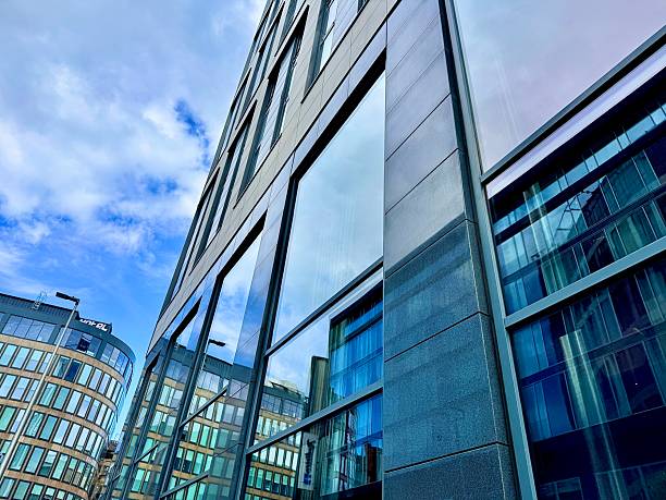 istock Modern urban architecture reflected in the windows of modern urban architecture in Glasgow city centre against cloudscape 2229194119