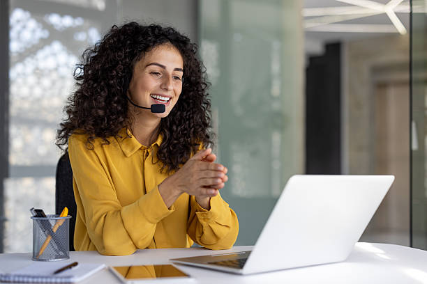 A friendly customer service representative is smiling during an online video call.