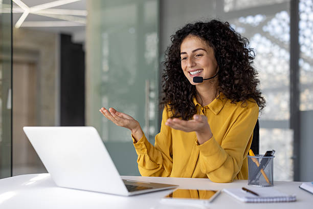 istock Support service worker at workplace inside office. Businesswoman talking using laptop for video call. Woman smiling and talking, consulting clients remotely 2229195555