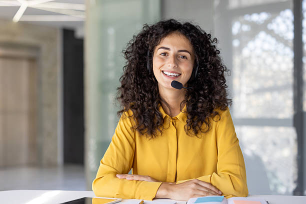 istock A smiling customer service representative wearing a headset at her desk 2229195564