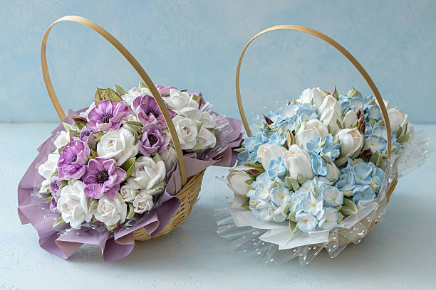 istock Two beautifully arranged flower baskets featuring purple and white roses alongside blue and white blossoms, showcasing vibrant colors and intricate floral design elements for decorative purposes 2229196579