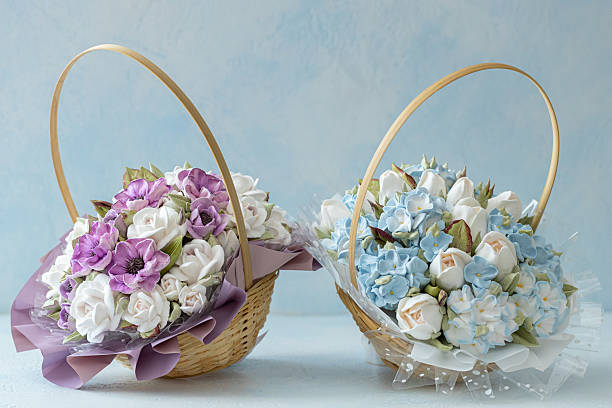 istock Two elegant baskets filled with vibrant artificial flowers, featuring purple and white blooms in one and soft blue and white flowers in the other, showcasing floral artistry and design 2229196603