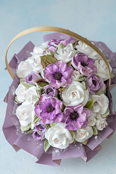 istock Beautiful floral arrangement featuring white and purple flowers in a decorative basket, showcasing intricate details and vibrant colors, perfect for celebrations and special occasions 2229196607