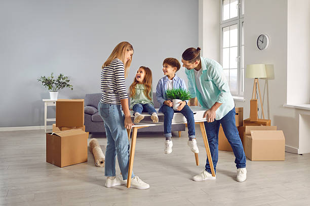 istock Happy family on moving day on a new home with unpacked boxes. 2229196836