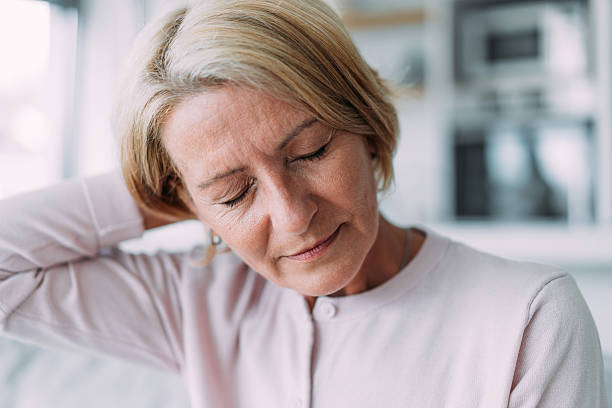 istock Woman suffering with a migraine. 2229200392