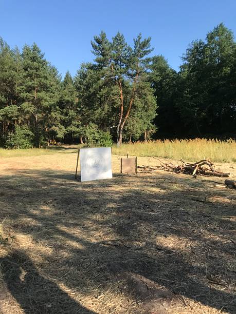istock Open clearing with targets set for shooting practice near forest 2229200795