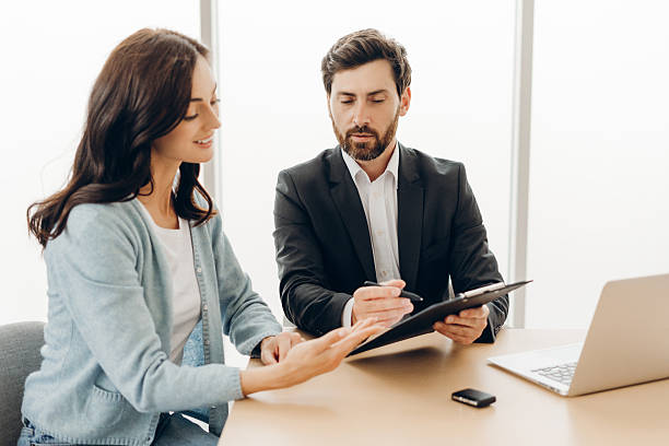 istock Financial advisor showing contract to client in office meeting 2229201310