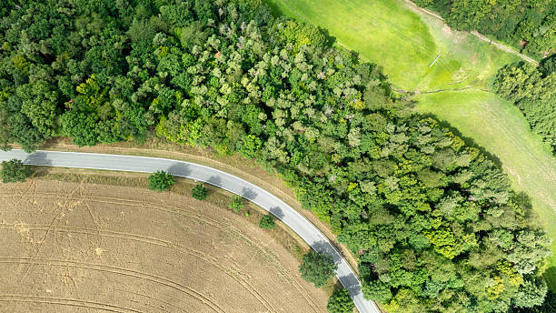 istock Road through a rural scene - aerial view 2229202726