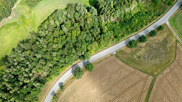 istock Road through a rural scene - aerial view 2229202758