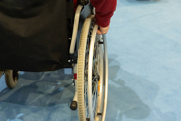 istock Individual maneuvering a wheelchair on a smooth surface with a focus on mobility and independence 2229204159