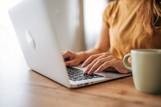istock Woman working from home on laptop with coffee 2229207906