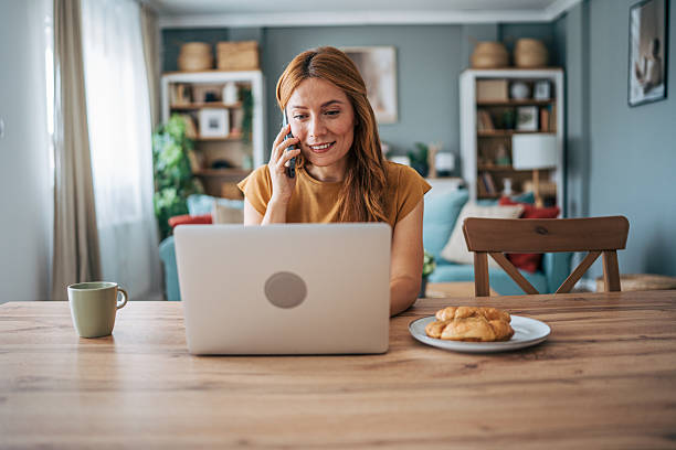 istock Woman working from home and having a phone call during breakfast 2229208084