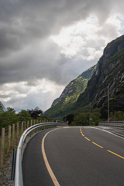 istock Winding Road with Guardrails and Mountainous Backdrop in Lysebotn 2229211691