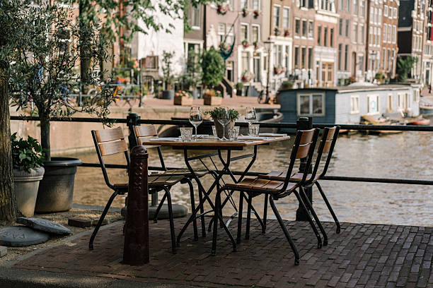 istock table and chairs in a cafe at a canal, Amsterdam 2229213065