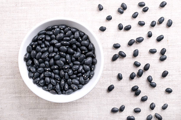 istock Dried black beans, turtle beans, in a white bowl, on linen 2229213741
