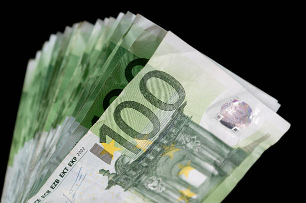 istock Close-up of a stack of 100 Euro notes against a black background 2229213869