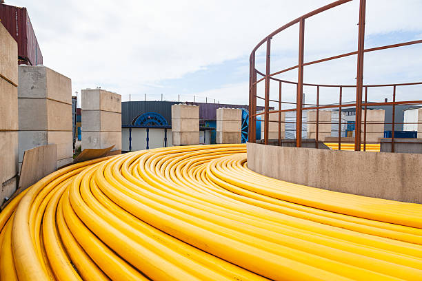 istock New powerful high-voltage cable in yellow braiding twisted on the ground. 2229217995