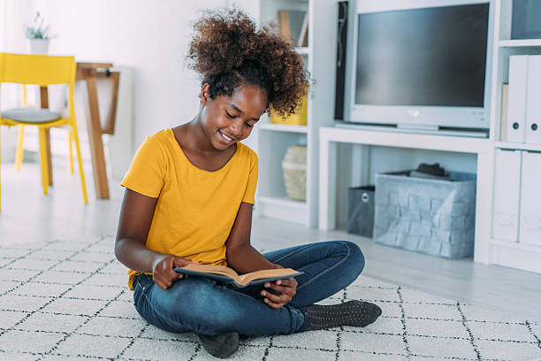 istock Girl reading a book at home. 2229220899