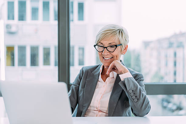 istock Successful businesswoman in modern office working on laptop. 2229220971