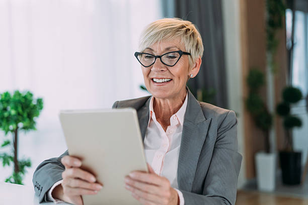 istock Successful businesswoman in modern office working on digital tablet. 2229220985