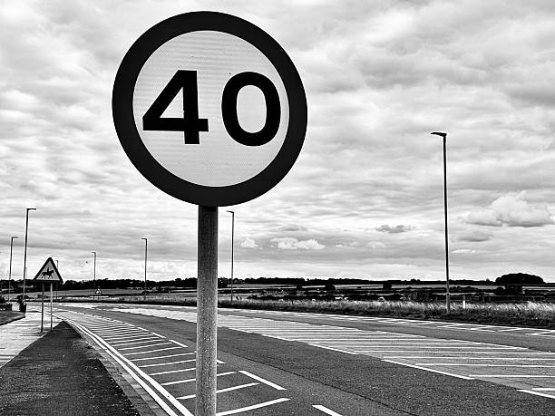 istock A circular 40 miles per hour road sign next to an empty road 2229226047