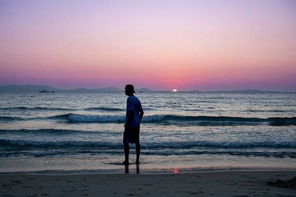istock Sunset Silhouette by the Shore 2229232365