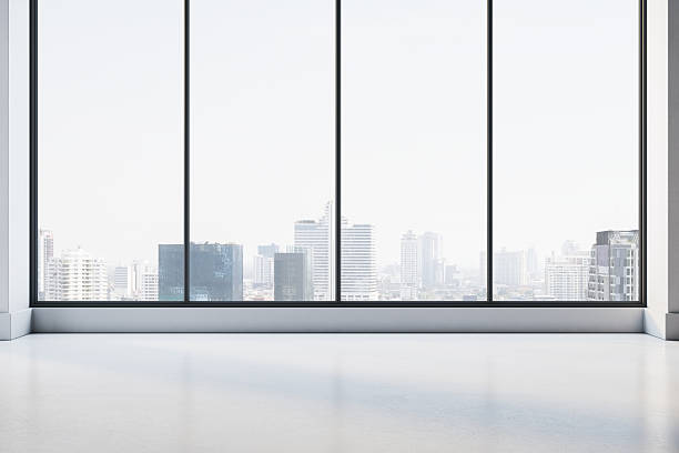 istock Modern empty office interior with large windows and city skyline view in daylight, perfect for business or creative corporate workspace concept. 3D Rendering 2229232838
