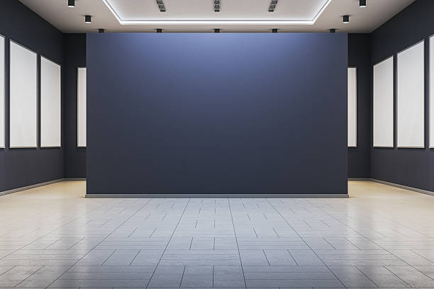 istock Contemporary gallery interior with blank blue exhibition wall and empty white frames for artwork or poster presentation mockup template. 3D Rendering 2229232912