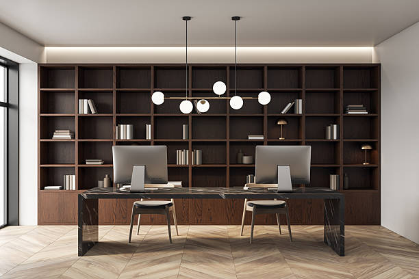 istock Modern empty office interior with two desktop computers, wooden furniture, and minimalist lighting in a sleek and creative workspace environment. 3D Rendering 2229233080